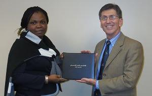 Kim McNutt presents certificate to Uche L Nnannah